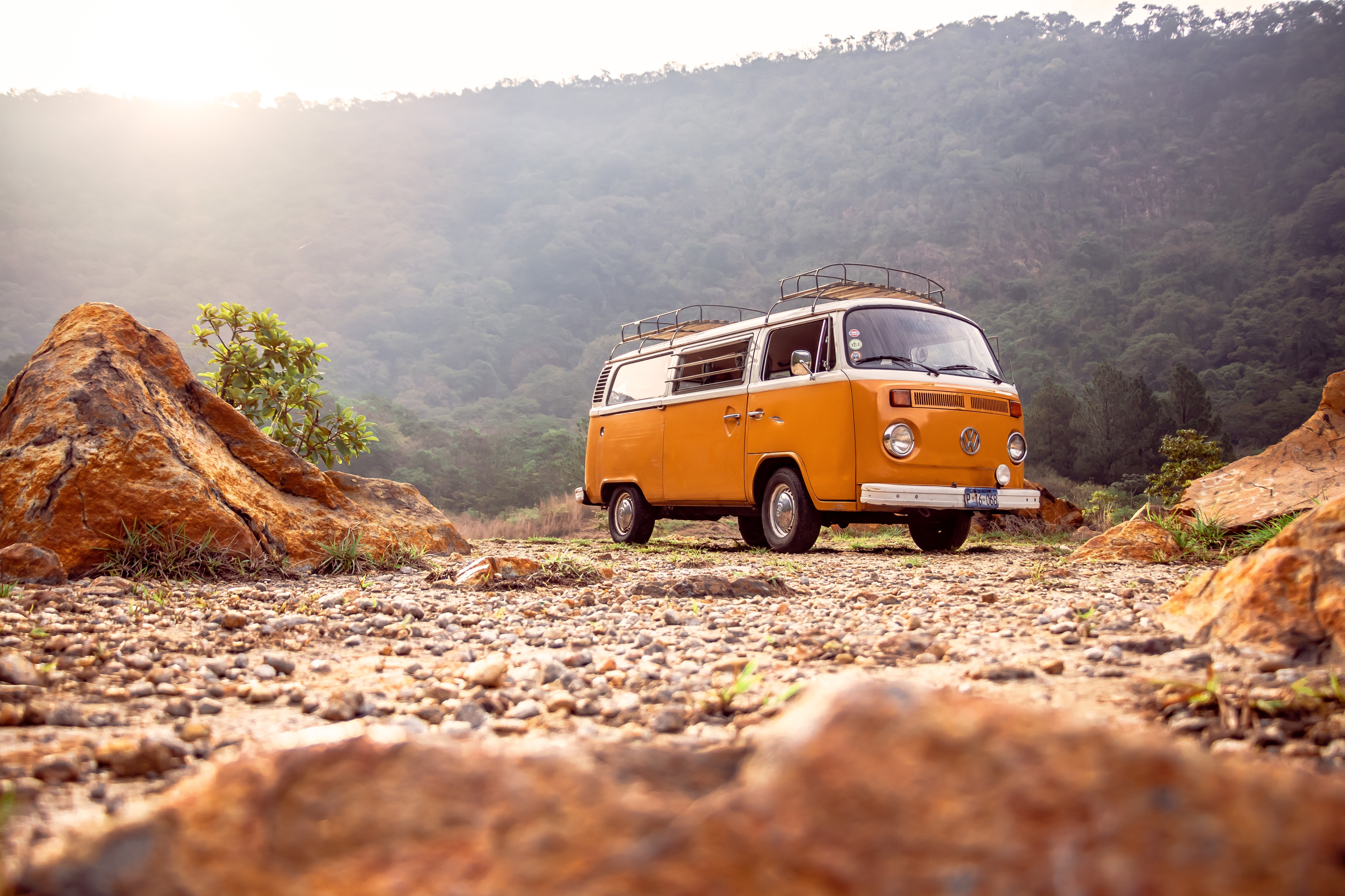 A photograph of an old white and orange volkswagen.