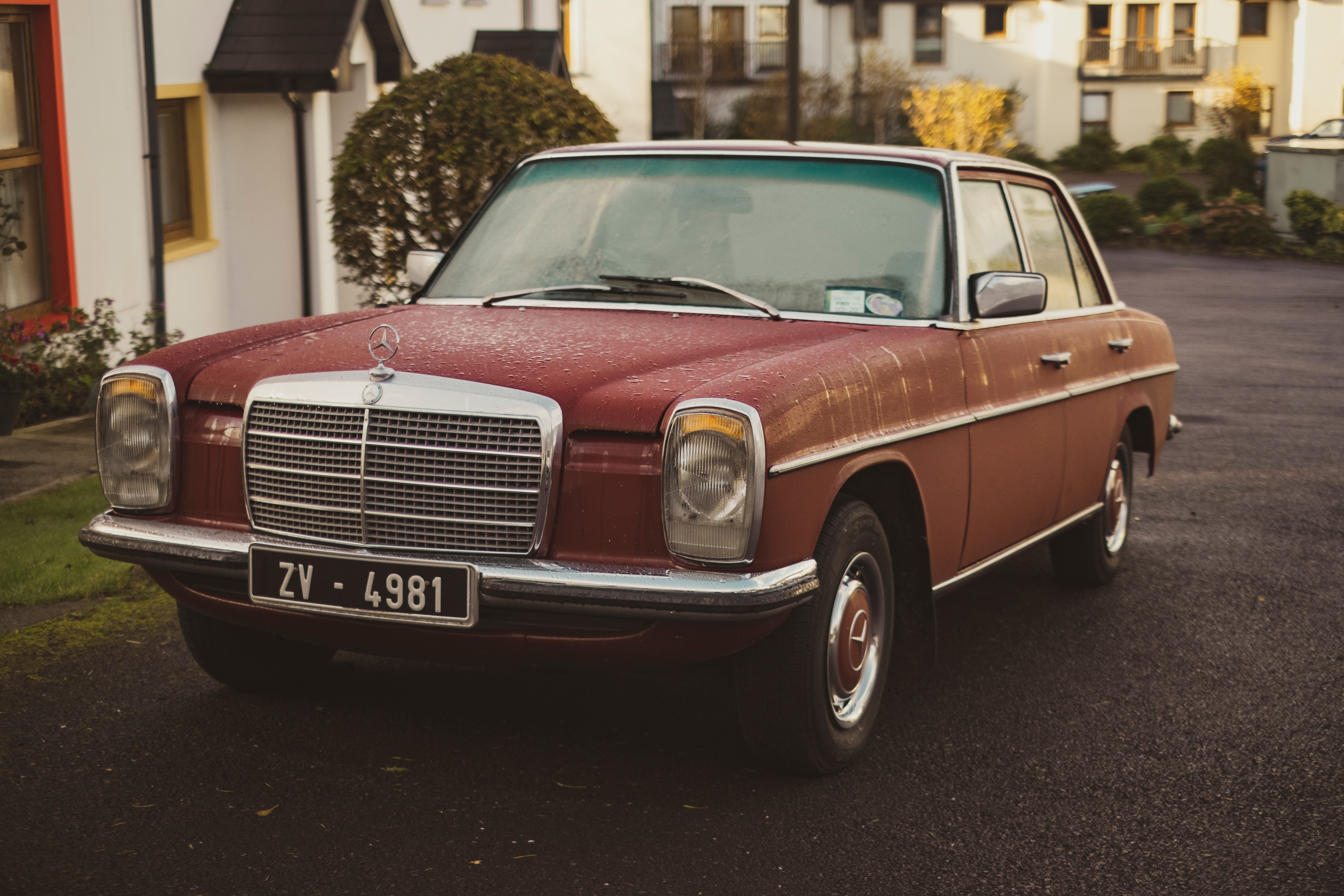 A photograph of an old red mercedes.